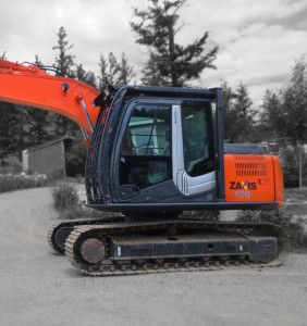 Excavator with FOPS installed to protect the operator. Front removeable screen installed