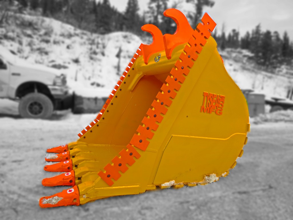 Yellow and orange heavy duty excavator dig bucket manufactured by Tysea Mfg Inc  Complete with serrated cutting edges and replaceable pin on teeth.