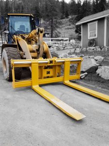 Pallet forks manufactured to customer specs by Tysea Mfg and installed on a wheel loader