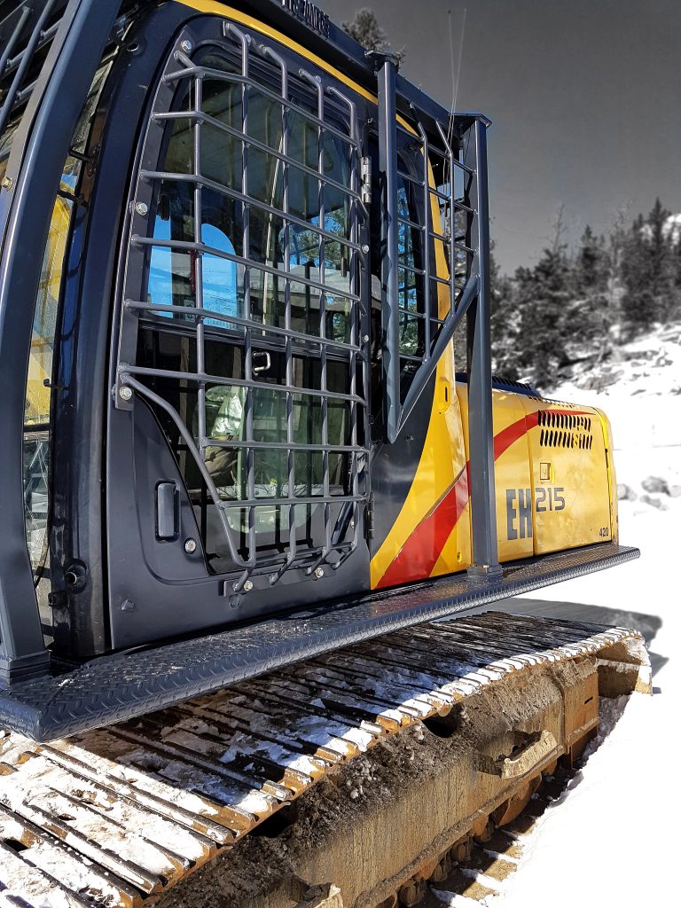 Excavator cab guard for operator protection with side door guarding installed, in addition to front window and rear window guarding.  Excavator catwalks installed