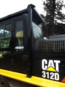Excavator FOPS installed on CAT 312D. Painted black with roof protection and supports. Custom catwalks installed on excavator.