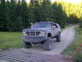 The crewban! Lifted GMC Sierra crewcab front end with a suburban back end on 40's. Limoed out to three doors.