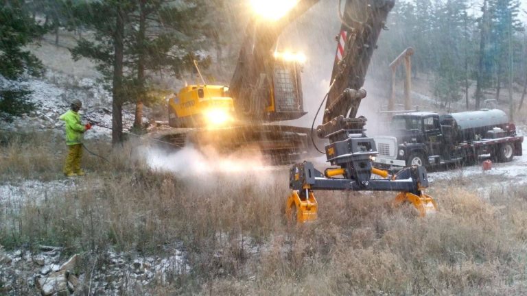 Pressure washing the pipe handler and excavator prior to shipping to Alberta, Canada.