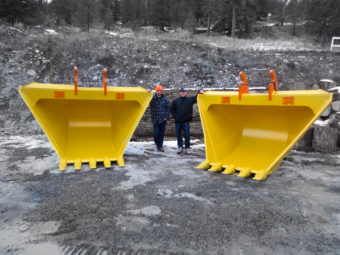 Kevin and Tyler standing next to two heavy duty excavator V buckets, manufactured for a customer in Alberta, Canada.