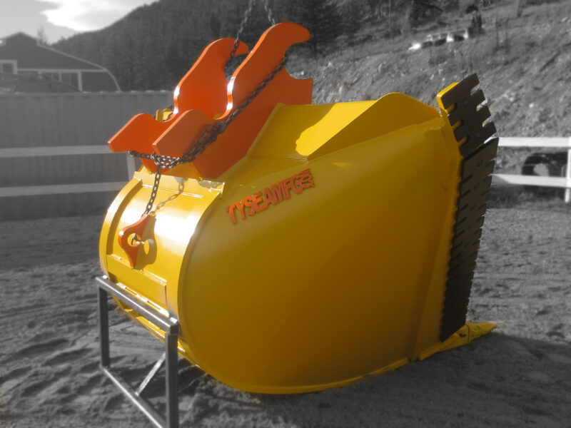 Yellow excavator bucket with black serrated side edges and bolt on teeth