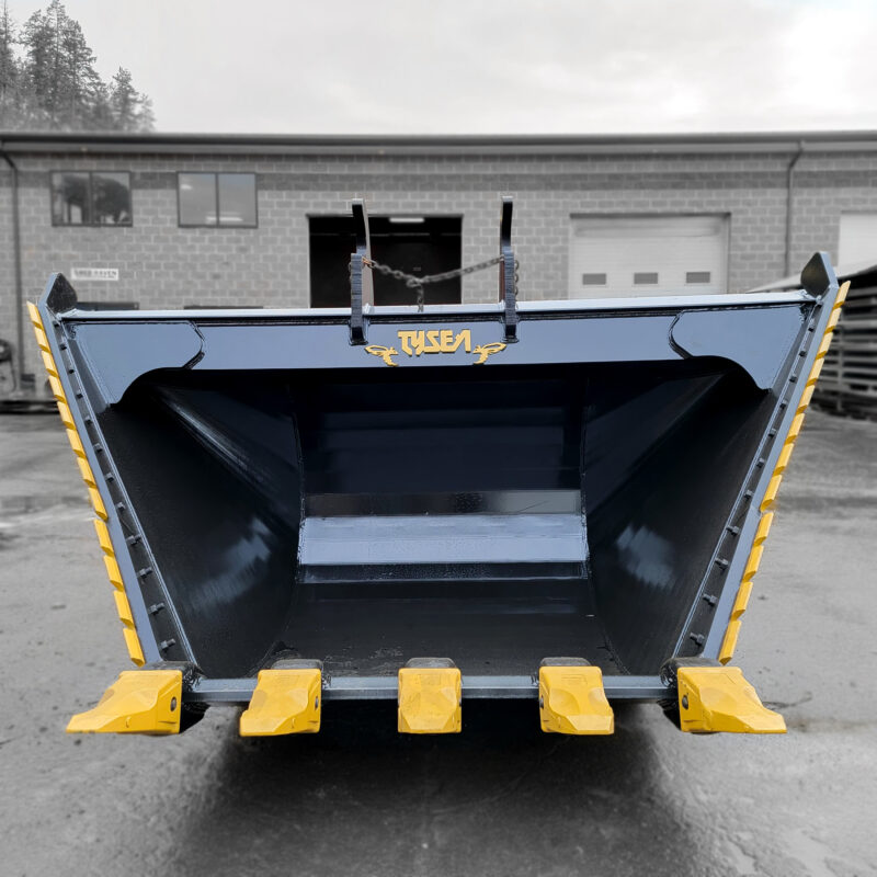 Black excavator v-bucket for trenching, with yellow serrated side edges and pin on teeth