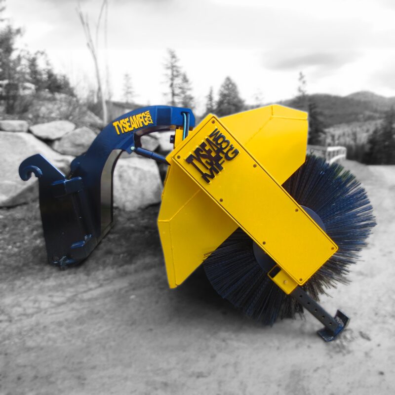 Wheel loader hydraulic angle broom on gravel driveway