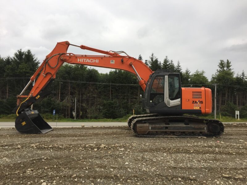 Excavator thumb and cleanup bucket installed onto a Hitachi Zaxis excavator for cleanup after flooding
