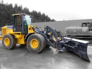 John Deere wheel loader with hydraulic angle snow blade installed