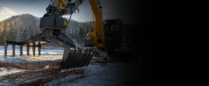 Excavator with mat grapple attachment moving wood rig mats