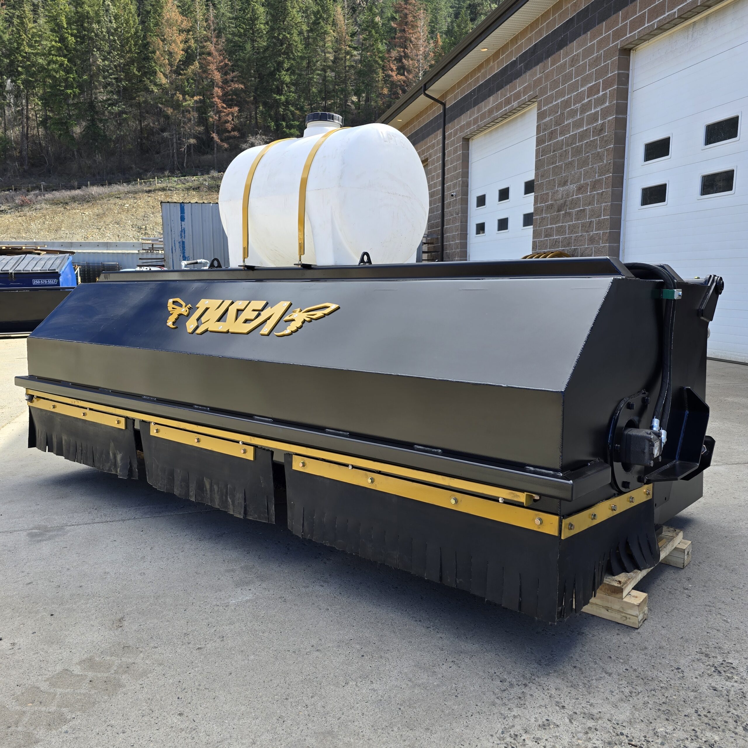 Wheel loader pickup broom with hopper bucket and tank system
