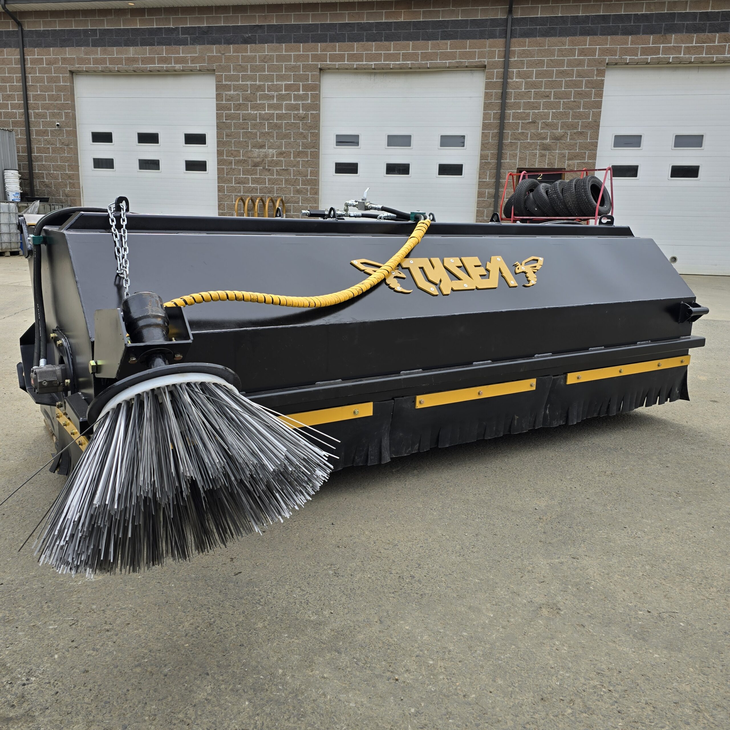 Wheel loader pickup broom with hopper bucket and tank system